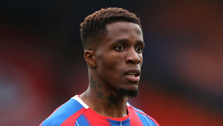 LONDON, ENGLAND - JULY 07: Wilfried Zaha of Crystal Palace looks on during the Premier League match between Crystal Palace and Chelsea FC at Selhurst Park on July 07, 2020 in London, England. Football Stadiums around Europe remain empty due to the Coronavirus Pandemic as Government social distancing laws prohibit fans inside venues resulting in all fixtures being played behind closed doors. (Photo by Peter Cziborra/Pool via Getty Images) LONDON, ENGLAND - JULY 07: Wilfried Zaha of Crystal Palace looks on during the Premier League match between Crystal Palace and Chelsea FC at Selhurst Park on July 07, 2020 in London, England. Football Stadiums around Europe remain empty due to the Coronavirus Pandemic as Government social distancing laws prohibit fans inside venues resulting in all fixtures being played behind closed doors. (Photo by Peter Cziborra/Pool via Getty Images)