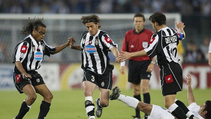 TURIN, ITALY - MAY 14: Alessio Tacchinardi of Juventus skips through a tackle with team mate Edgar Davids at hand during the UEFA Champions League semi final second leg match between Juventus and Real Madrid on May 14, 2003, at the Stadio Delle Alpi in Turin, Italy. (Photo by Clive Mason/Getty Images) TURIN, ITALY - MAY 14: Alessio Tacchinardi of Juventus skips through a tackle with team mate Edgar Davids at hand during the UEFA Champions League semi final second leg match between Juventus and Real Madrid on May 14, 2003, at the Stadio Delle Alpi in Turin, Italy. (Photo by Clive Mason/Getty Images)