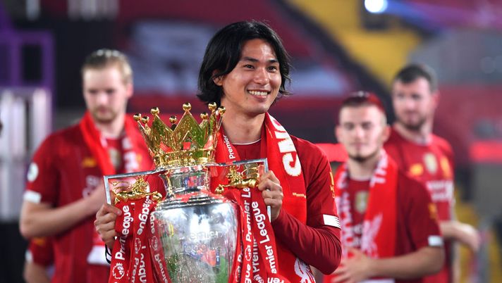 LIVERPOOL, ENGLAND - JULY 22: Takumi Minamino of Liverpool celebrates with The Premier League trophy following the Premier League match between Liverpool FC and Chelsea FC at Anfield on July 22, 2020 in Liverpool, England. Football Stadiums around Europe remain empty due to the Coronavirus Pandemic as Government social distancing laws prohibit fans inside venues resulting in all fixtures being played behind closed doors. (Photo by Laurence Griffiths/Getty Images) LIVERPOOL, ENGLAND - JULY 22: Takumi Minamino of Liverpool celebrates with The Premier League trophy following the Premier League match between Liverpool FC and Chelsea FC at Anfield on July 22, 2020 in Liverpool, England. Football Stadiums around Europe remain empty due to the Coronavirus Pandemic as Government social distancing laws prohibit fans inside venues resulting in all fixtures being played behind closed doors. (Photo by Laurence Griffiths/Getty Images)