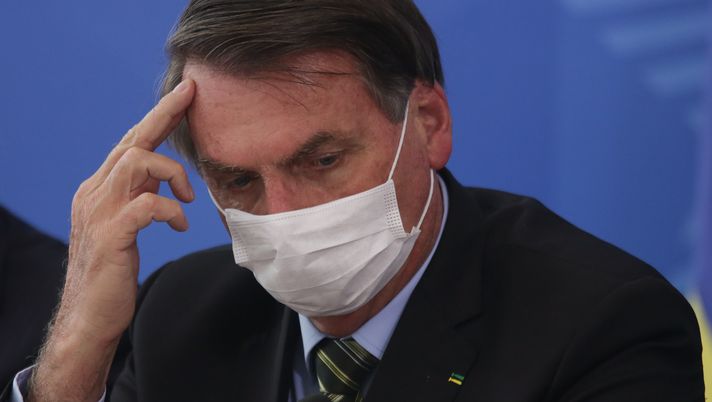 BRASILIA, BRAZIL - MARCH 18: President of Brazil Jair Bolsonaro wears a protective mask as he listens during a press conference about government plans and measures about the Coronavirus (COVID-19) Outbreak in Brazil, at the Planalto Palace on March 18, 2020 in Brasilia, Brazil. (Photo by Andre Coelho/Getty Images) BRASILIA, BRAZIL - MARCH 18: President of Brazil Jair Bolsonaro wears a protective mask as he listens during a press conference about government plans and measures about the Coronavirus (COVID-19) Outbreak in Brazil, at the Planalto Palace on March 18, 2020 in Brasilia, Brazil. (Photo by Andre Coelho/Getty Images)