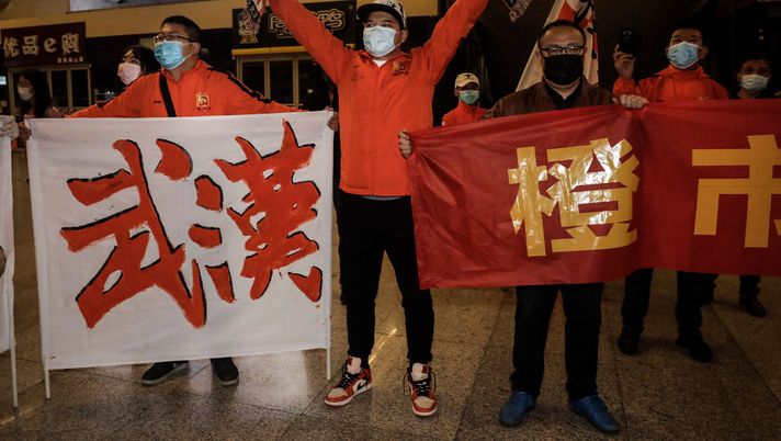 WUHAN, CHINA - APRIL 18:(CHINA OUT) Supporters of Wuhan Zall football team welcome the team when they arrive arrive at Wuhan railway station on April 18, 2020 in Hubei, China. The Wuhan Zall football team left Wuhan on January 5, 2020 for a training session in Guangzhou of Guangdong Province. Since then the team has spent 104 days training in Malaga, Spain and other cities in Guangdong before finally returning to Wuhan on Saturday, finishing a prolonged journey during the Coronavirus (COVID-19) pandemic.(Photo by Getty Images) WUHAN, CHINA - APRIL 18:(CHINA OUT) Supporters of Wuhan Zall football team welcome the team when they arrive arrive at Wuhan railway station on April 18, 2020 in Hubei, China. The Wuhan Zall football team left Wuhan on January 5, 2020 for a training session in Guangzhou of Guangdong Province. Since then the team has spent 104 days training in Malaga, Spain and other cities in Guangdong before finally returning to Wuhan on Saturday, finishing a prolonged journey during the Coronavirus (COVID-19) pandemic.(Photo by Getty Images)