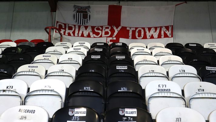 GRIMSBY, ENGLAND - MARCH 17: A general view of a Grimsby Town England flag inside the stadium prior to the Sky Bet League Two match between Grimsby Town and Tranmere Rovers at Blundell Park on March 17, 2021 in Grimsby, England. Sporting stadiums around the UK remain under strict restrictions due to the Coronavirus Pandemic as Government social distancing laws prohibit fans inside venues resulting in games being played behind closed doors. (Photo by George Wood/Getty Images) GRIMSBY, ENGLAND - MARCH 17: A general view of a Grimsby Town England flag inside the stadium prior to the Sky Bet League Two match between Grimsby Town and Tranmere Rovers at Blundell Park on March 17, 2021 in Grimsby, England. Sporting stadiums around the UK remain under strict restrictions due to the Coronavirus Pandemic as Government social distancing laws prohibit fans inside venues resulting in games being played behind closed doors. (Photo by George Wood/Getty Images)