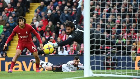 LIVERPOOL, ENGLAND - MARCH 05: Bruno Fernandes of Manchester United reacts as their shot narrowly misses the post as Trent Alexander-Arnold and Alisson Becker of Liverpool look on during the Premier League match between Liverpool FC and Manchester United at Anfield on March 05, 2023 in Liverpool, England. (Photo by Michael Regan/Getty Images)
