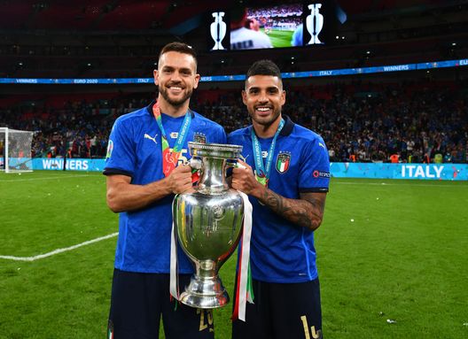 LONDON, ENGLAND - JULY 11: Rafael Toloi and Emerson Palmieri of Italy celebrate with The Henri Delaunay Trophy following his team's victory in the UEFA Euro 2020 Championship Final between Italy and England at Wembley Stadium on July 11, 2021 in London, England. (Photo by Claudio Villa/Getty Images) LONDON, ENGLAND - JULY 11: Rafael Toloi and Emerson Palmieri of Italy celebrate with The Henri Delaunay Trophy following his team's victory in the UEFA Euro 2020 Championship Final between Italy and England at Wembley Stadium on July 11, 2021 in London, England. (Photo by Claudio Villa/Getty Images)
