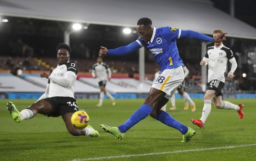  LONDON, ENGLAND - DECEMBER 16: Danny Welbeck of Brighton and Hove Albion is challenged by Ola Aina of Fulham during the Premier League match between Fulham and Brighton &amp; Hove Albion at Craven Cottage on December 16, 2020 in London, England. The match will be played without fans, behind closed doors as a Covid-19 precaution. (Photo by Matthew Childs - Pool/Getty Images) 