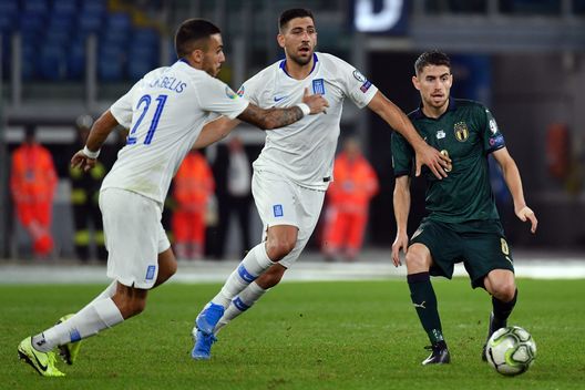 ROME, ITALY - OCTOBER 12: Jorginho of Italy compete for the ball with Tasos Bakasetas in action during the UEFA Euro 2020 qualifier between Italy and Greece on October 12, 2019 in Rome, Italy. (Photo by Marco Rosi/Getty Images)