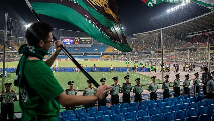 CHINA OUT BEIJING, CHINA - JUNE 20: Ultra supporters of the Beijing Guoan FC wave flags as police stand guard during their Chinese Super League match against Tianjin FC on June 20, 2015 in Beijing, China. There are growing legions of ardent supporters and fans of China's football clubs. The government is also trying to foster a football culture in the country by mandating football programs in 20,000 Chinese schools in a recent plan devised by President Xi Jinping. (Photo by Kevin Frayer/Getty Images) CHINA OUT BEIJING, CHINA - JUNE 20: Ultra supporters of the Beijing Guoan FC wave flags as police stand guard during their Chinese Super League match against Tianjin FC on June 20, 2015 in Beijing, China. There are growing legions of ardent supporters and fans of China's football clubs. The government is also trying to foster a football culture in the country by mandating football programs in 20,000 Chinese schools in a recent plan devised by President Xi Jinping. (Photo by Kevin Frayer/Getty Images)