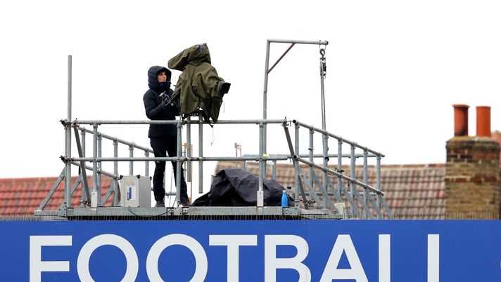 KINGSTON UPON THAMES, ENGLAND - MAY 02: A television camera on the top of the stand above the word football during the Second Leg of the UEFA Women's Champions League Semi Final match between Chelsea FC and Bayern Munich at The Cherry Red Records Stadium on May 02, 2021 in Kingston upon Thames, England. Sporting stadiums around the UK remain under strict restrictions due to the Coronavirus Pandemic as Government social distancing laws prohibit fans inside venues resulting in games being played behind closed doors. (Photo by Catherine Ivill/Getty Images) KINGSTON UPON THAMES, ENGLAND - MAY 02: A television camera on the top of the stand above the word football during the Second Leg of the UEFA Women's Champions League Semi Final match between Chelsea FC and Bayern Munich at The Cherry Red Records Stadium on May 02, 2021 in Kingston upon Thames, England. Sporting stadiums around the UK remain under strict restrictions due to the Coronavirus Pandemic as Government social distancing laws prohibit fans inside venues resulting in games being played behind closed doors. (Photo by Catherine Ivill/Getty Images)