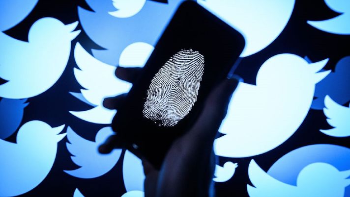 LONDON, ENGLAND - AUGUST 09:  In this photo illustration, a thumbprint is displayed on a mobile phone as the logo for the Twitter social media network is projected onto a screen on August 09, 2017 in London, England. With around 328 million users worldwide, Twitter has gone from a small start-up in for the public 2006 to a broadcast tool of politicians and corporations in 2017.  (Photo by Leon Neal/Getty Images) 