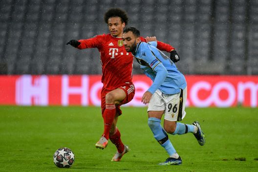  MUNICH, GERMANY - MARCH 17: Mohamed Fares of SS Lazio fights for the ball against Leroy Sane of Bayern München during the UEFA Champions League Round of 16 match between Bayern München and SS Lazio at Allianz Arena on March 17, 2021 in Munich, Germany. (Photo by Marco Rosi - SS Lazio/Getty Images) 