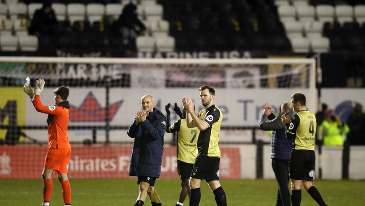 CROSBY, ENGLAND - JANUARY 10: David Raven and Danny Shaw of Marine applaud fans who watched the game from neighboring gardens at full-time after the FA Cup Third Round match between Marine and Tottenham Hotspur at Rossett Park on January 10, 2021 in Crosby, England. Sporting stadiums around England remain under strict restrictions due to the Coronavirus Pandemic as Government social distancing laws prohibit fans inside venues resulting in games being played behind closed doors. (Photo by Martin Rickett - Pool/Getty Images) CROSBY, ENGLAND - JANUARY 10: David Raven and Danny Shaw of Marine applaud fans who watched the game from neighboring gardens at full-time after the FA Cup Third Round match between Marine and Tottenham Hotspur at Rossett Park on January 10, 2021 in Crosby, England. Sporting stadiums around England remain under strict restrictions due to the Coronavirus Pandemic as Government social distancing laws prohibit fans inside venues resulting in games being played behind closed doors. (Photo by Martin Rickett - Pool/Getty Images)