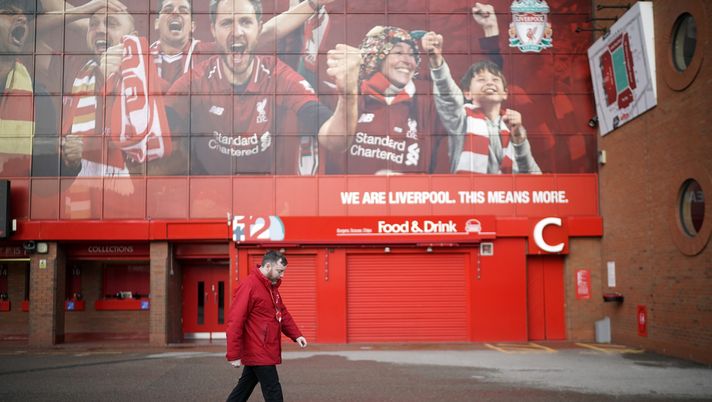 LIVERPOOL, - MARCH 13: A worker walks by Anfield Stadium, the home Liverpool Football Club on March 13, 2020 in Liverpool, United Kingdom. It has been announced that all football league matches, including the Premier League and Women’s Super League, have been postponed until at least April 3 in response to the threat of coronavirus. This follows UEFA's decision to suspend fixtures in the Champion's League and the Europa League, as many top flight players enter self-isolation. (Photo by Christopher Furlong/Getty Images) LIVERPOOL, - MARCH 13: A worker walks by Anfield Stadium, the home Liverpool Football Club on March 13, 2020 in Liverpool, United Kingdom. It has been announced that all football league matches, including the Premier League and Women’s Super League, have been postponed until at least April 3 in response to the threat of coronavirus. This follows UEFA's decision to suspend fixtures in the Champion's League and the Europa League, as many top flight players enter self-isolation. (Photo by Christopher Furlong/Getty Images)