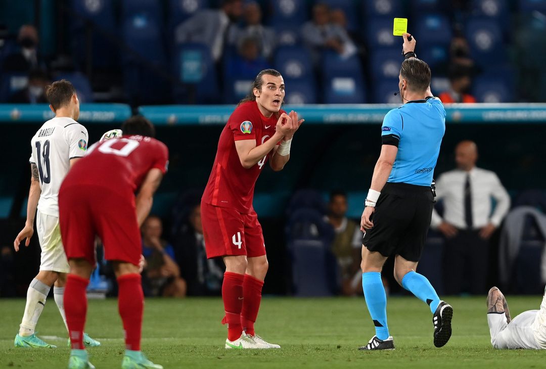  ROME, ITALY - JUNE 11: Caglar Soyuncu of Turkey is shown a yellow card by Match Referee, Danny Makkelie during the UEFA Euro 2020 Championship Group A match between Turkey and Italy at the Stadio Olimpico on June 11, 2021 in Rome, Italy. (Photo by Mike Hewitt/Getty Images) 