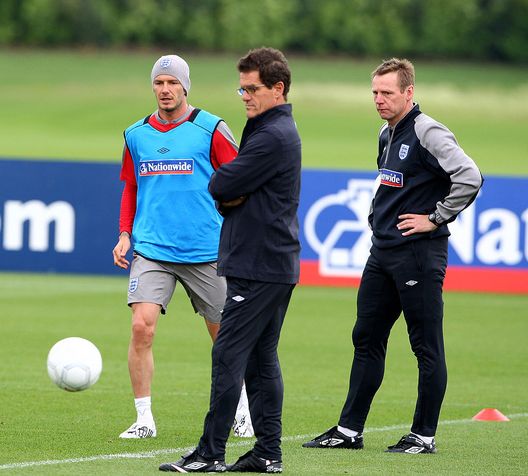 LONDON COLNEY, ENGLAND - JUNE 09: David Beckham of England trains as England Manager Fabio Capello (C) and Stuart Pearce (R) watch the players during an England training session on June 9, 2009 in London Colney, England. (Photo by Phil Cole/Getty Images) LONDON COLNEY, ENGLAND - JUNE 09: David Beckham of England trains as England Manager Fabio Capello (C) and Stuart Pearce (R) watch the players during an England training session on June 9, 2009 in London Colney, England. (Photo by Phil Cole/Getty Images)