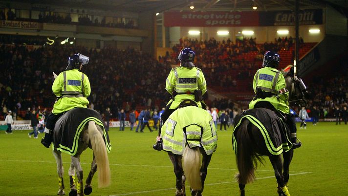 SHEFFIELD - NOVEMBER 6: Police horses and riot police try to contain the crowd as Sheffield United fans invade the pitch after the Worthington Cup third round match between Sheffield United and Leeds United held on November 6, 2002 at Bramall Lane, in Sheffield, England. Sheffield United won the match 2-1. DIGITAL IMAGE. (Photo by Laurence Griffiths/Getty Images) SHEFFIELD - NOVEMBER 6: Police horses and riot police try to contain the crowd as Sheffield United fans invade the pitch after the Worthington Cup third round match between Sheffield United and Leeds United held on November 6, 2002 at Bramall Lane, in Sheffield, England. Sheffield United won the match 2-1. DIGITAL IMAGE. (Photo by Laurence Griffiths/Getty Images)
