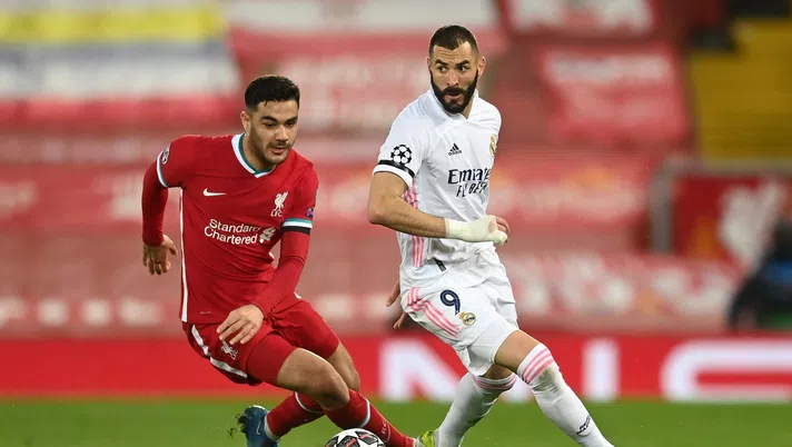 LIVERPOOL, ENGLAND - APRIL 14: Ozan Kabak of Liverpool battles for possession with Karim Benzema of Real Madrid during the UEFA Champions League Quarter Final Second Leg match between Liverpool FC and Real Madrid at Anfield on April 14, 2021 in Liverpool, England. Sporting stadiums around the UK remain under strict restrictions due to the Coronavirus Pandemic as Government social distancing laws prohibit fans inside venues resulting in games being played behind closed doors. (Photo by Michael Regan/Getty Images)
