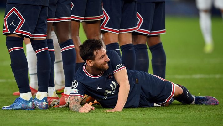 PARIS, FRANCE - SEPTEMBER 28: Lionel Messi of Paris Saint-Germain lies behind the Paris Saint-Germain wall as they defend a free kick during the UEFA Champions League group A match between Paris Saint-Germain and Manchester City at Parc des Princes on September 28, 2021 in Paris, France. (Photo by Matthias Hangst/Getty Images) PSG, Messi…si ripaga da solo: 8 nuovi sponsor dopo il suo arrivo e un milione di magliette vendute! - immagine 1