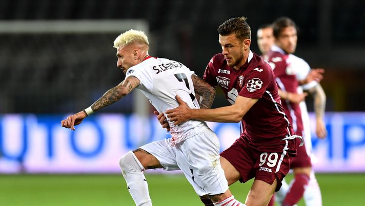 TURIN, ITALY - MAY 12: Samu Castillejo of A.C. Milan is challenged by Alessandro Buongiorno of Torino FC during the Serie A match between Torino FC  and AC Milan at Stadio Olimpico di Torino on May 12, 2021 in Turin, Italy. Sporting stadiums around Italy remain under strict restrictions due to the Coronavirus Pandemic as Government social distancing laws prohibit fans inside venues resulting in games being played behind closed doors. (Photo by Valerio Pennicino/Getty Images) 