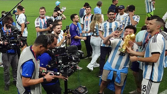 LUSAIL CITY, QATAR - DECEMBER 18: (EDITORS NOTE: In this photo taken from a remote camera from inside the goal) Argentina's Guido Rodriguez celebrate winning the World Cup with the trophy and friends and family after the FIFA World Cup Qatar 2022 Final match between Argentina and France at Lusail Stadium on December 18, 2022 in Lusail City, Qatar. (Photo by Carl Recine - Pool/Getty Images) RIVALITA' SIVIGLIANE