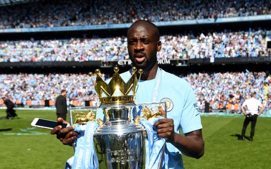 MANCHESTER, ENGLAND - MAY 06: Yaya Toure of Manchester City celebrates with The Premier League Trophy after the Premier League match between Manchester City and Huddersfield Town at Etihad Stadium on May 6, 2018 in Manchester, England.  (Photo by Michael Regan/Getty Images) 