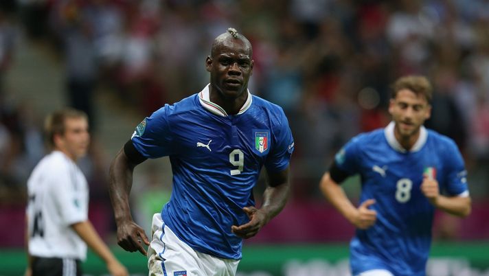 WARSAW, POLAND - JUNE 28: Mario Balotelli of Italy celebrates scoring the opening goal during the UEFA EURO 2012 semi final match between Germany and Italy at the National Stadium on June 28, 2012 in Warsaw, Poland. (Photo by Joern Pollex/Getty Images)