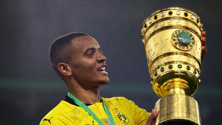 BERLIN, GERMANY - MAY 13: Manuel Akanji of Borussia Dortmund celebrates with the trophy after winning the DFB Cup final match between RB Leipzig and Borussia Dortmund at Olympic Stadium on May 13, 2021 in Berlin, Germany. Sporting stadiums around Germany remain under strict restrictions due to the Coronavirus Pandemic as Government social distancing laws prohibit fans inside venues resulting in games being played behind closed doors. (Photo by Martin Rose/Getty Images)