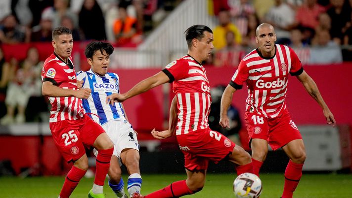GIRONA, SPAIN - OCTOBER 02: Takefusa Kubo of Real Sociedad being followed by Manu Vallejo, Bernardo Espinosa and Oriol Romeu of Girona FC during the LaLiga Santander match between Girona FC and Real Sociedad at Montilivi Stadium on October 02, 2022 in Girona, Spain. (Photo by Alex Caparros/Getty Images) Real Sociedad