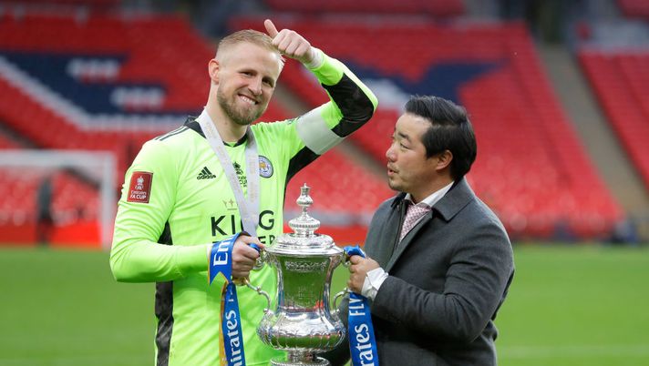 LONDON, ENGLAND - MAY 15: Khun Top, Chairman of Leicester City and Kasper Schmeichel of Leicester City celebrate with the Emirates FA Cup trophy following The Emirates FA Cup Final match between Chelsea and Leicester City at Wembley Stadium on May 15, 2021 in London, England. A limited number of around 21,000 fans, subject to a negative lateral flow test, will be allowed inside Wembley Stadium to watch this year's FA Cup Final as part of a pilot event to trial the return of large crowds to UK venues. (Photo by Kirsty Wigglesworth - Pool/Getty Images) LONDON, ENGLAND - MAY 15: Khun Top, Chairman of Leicester City and Kasper Schmeichel of Leicester City celebrate with the Emirates FA Cup trophy following The Emirates FA Cup Final match between Chelsea and Leicester City at Wembley Stadium on May 15, 2021 in London, England. A limited number of around 21,000 fans, subject to a negative lateral flow test, will be allowed inside Wembley Stadium to watch this year's FA Cup Final as part of a pilot event to trial the return of large crowds to UK venues. (Photo by Kirsty Wigglesworth - Pool/Getty Images)