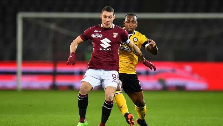 TURIN, ITALY - DECEMBER 12: Andrea Belotti of Torino F.C.  is put under pressure by Samir of Udinese Calcio  during the Serie A match between Torino FC and Udinese Calcio at Stadio Olimpico di Torino on December 12, 2020 in Turin, Italy. Sporting stadiums around Italy remain under strict restrictions due to the Coronavirus Pandemic as Government social distancing laws prohibit fans inside venues resulting in games being played behind closed doors. (Photo by Valerio Pennicino/Getty Images)