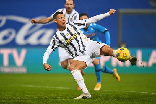 REGGIO NELL'EMILIA, ITALY - JANUARY 20: Cristiano Ronaldo of Juventus scores their sides first goal during the Italian PS5 Supercup match between Juventus and SSC Napoli at Mapei Stadium - Citta' del Tricolore on January 20, 2021 in Reggio nell'Emilia, Italy. Sporting stadiums around Italy remain under strict restrictions due to the Coronavirus Pandemic as Government social distancing laws prohibit fans inside venues resulting in games being played behind closed doors. (Photo by Claudio Villa/Getty Images) 