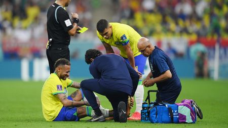 LUSAIL CITY, QATAR - NOVEMBER 24: Neymar of Brazil is attended to by medical staff during the FIFA World Cup Qatar 2022 Group G match between Brazil and Serbia at Lusail Stadium on November 24, 2022 in Lusail City, Qatar. (Photo by Justin Setterfield/Getty Images)