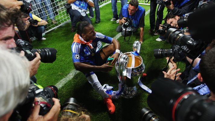 MUNICH, GERMANY - MAY 19: Didier Drogba of Chelsea celebrates with the trophy surrounded by photographers after their victory in the UEFA Champions League Final between FC Bayern Muenchen and Chelsea at the Fussball Arena München on May 19, 2012 in Munich, Germany. (Photo by Alex Livesey/Getty Images) MUNICH, GERMANY - MAY 19: Didier Drogba of Chelsea celebrates with the trophy surrounded by photographers after their victory in the UEFA Champions League Final between FC Bayern Muenchen and Chelsea at the Fussball Arena München on May 19, 2012 in Munich, Germany. (Photo by Alex Livesey/Getty Images)