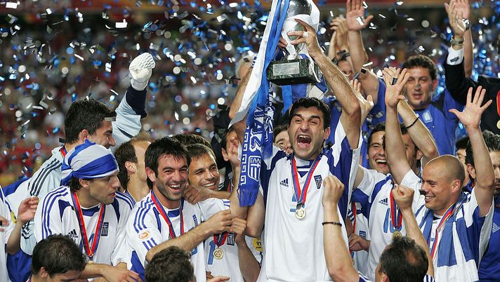 LISBON, PORTUGAL - JULY 4:  Traianos Dellas of Greece lifts the trophy during the UEFA Euro 2004 Final match between Portugal and Greece at the Luz Stadium on July 4, 2004 in Lisbon, Portugal. (Photo by Alex Livesey/Getty Images) 
