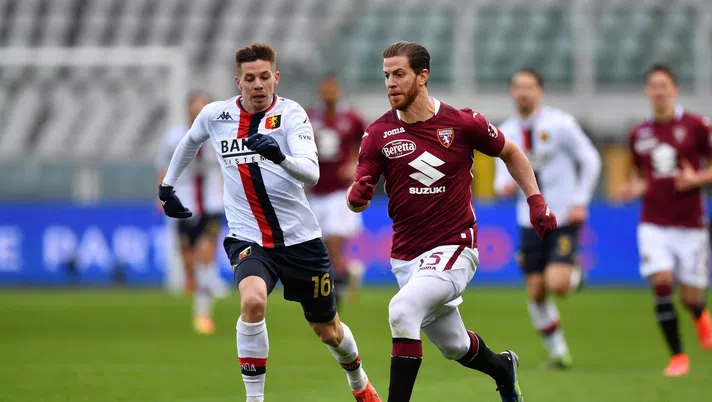 TURIN, ITALY - FEBRUARY 13: Cristian Ansaldi of Torino FC runs with the ball under pressure from Miha Zajc of Genoa C.F.C. during the Serie A match between Torino FC  and Genoa CFC at Stadio Olimpico di Torino on February 13, 2021 in Turin, Italy. Sporting stadiums around Italy remain under strict restrictions due to the Coronavirus Pandemic as Government social distancing laws prohibit fans inside venues resulting in games being played behind closed doors. (Photo by Valerio Pennicino/Getty Images)