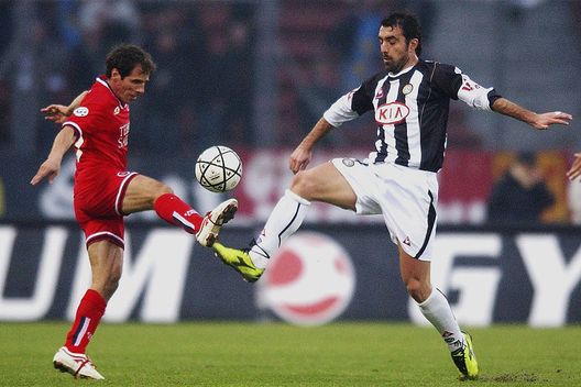 UDINE, ITALY - JANUARY 9: Valerio Bertotto of Udinese competes for the ball with Gianfranco Zola of Cagliari during the Serie A match between Udinese and Cagliari at the Friuli stadium on January 9, 2005 in Udine, Italy. (Photo by Newpress/Getty Images) UDINE, ITALY - JANUARY 9: Valerio Bertotto of Udinese competes for the ball with Gianfranco Zola of Cagliari during the Serie A match between Udinese and Cagliari at the Friuli stadium on January 9, 2005 in Udine, Italy. (Photo by Newpress/Getty Images)