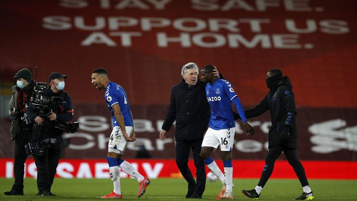 LIVERPOOL, ENGLAND - FEBRUARY 20: Mason Holgate of Everton celebrates as Carlo Ancelotti, Manager of Everton speaks with Abdoulaye Doucoure of Everton following their team's victory in the Premier League match between Liverpool and Everton at Anfield on February 20, 2021 in Liverpool, England. Sporting stadiums around the UK remain under strict restrictions due to the Coronavirus Pandemic as Government social distancing laws prohibit fans inside venues resulting in games being played behind closed doors. (Photo by Phil Noble - Pool/Getty Images) LIVERPOOL, ENGLAND - FEBRUARY 20: Mason Holgate of Everton celebrates as Carlo Ancelotti, Manager of Everton speaks with Abdoulaye Doucoure of Everton following their team's victory in the Premier League match between Liverpool and Everton at Anfield on February 20, 2021 in Liverpool, England. Sporting stadiums around the UK remain under strict restrictions due to the Coronavirus Pandemic as Government social distancing laws prohibit fans inside venues resulting in games being played behind closed doors. (Photo by Phil Noble - Pool/Getty Images)