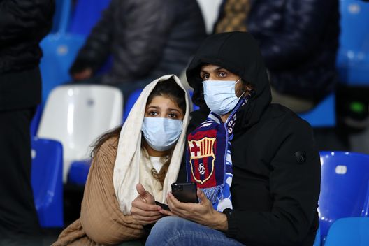 NAPLES, ITALY - FEBRUARY 25: Fans wear medical face masks as they await kick off prior to the UEFA Champions League round of 16 first leg match between SSC Napoli and FC Barcelona at Stadio San Paolo on February 25, 2020 in Naples, Italy. (Photo by Michael Steele/Getty Images) NAPLES, ITALY - FEBRUARY 25: Fans wear medical face masks as they await kick off prior to the UEFA Champions League round of 16 first leg match between SSC Napoli and FC Barcelona at Stadio San Paolo on February 25, 2020 in Naples, Italy. (Photo by Michael Steele/Getty Images)