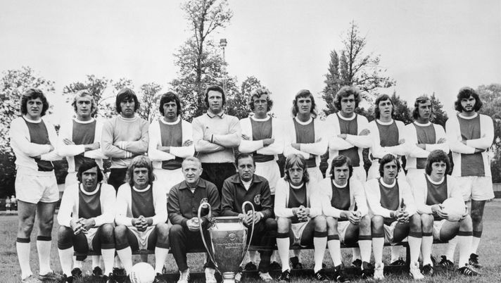 European Cup holders Ajax pose for a team photo with the trophy, 30th March 1973. Front row left to right, Sjaak Swart, Johnny Rep, coach Stephan Kovacs, trainer Bob Haarms, Ger Kleton, Jan Mulder, Johan Cruyff and Gerrie Muhren. Back row, left to right, Arie Haan, Horst Blankenburg, Sies Wever, Wim Suurbier, goalkeeper Heinz Stuy, Piet Keizer, Ruud Krol, Heinz Schilcher, Arnold Muhren, Johan Neeskens and Barry Hulshoff. (Photo by Central Press/Hulton Archive/Getty Images) European Cup holders Ajax pose for a team photo with the trophy, 30th March 1973. Front row left to right, Sjaak Swart, Johnny Rep, coach Stephan Kovacs, trainer Bob Haarms, Ger Kleton, Jan Mulder, Johan Cruyff and Gerrie Muhren. Back row, left to right, Arie Haan, Horst Blankenburg, Sies Wever, Wim Suurbier, goalkeeper Heinz Stuy, Piet Keizer, Ruud Krol, Heinz Schilcher, Arnold Muhren, Johan Neeskens and Barry Hulshoff. (Photo by Central Press/Hulton Archive/Getty Images)