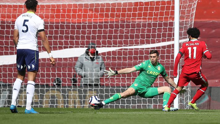 LIVERPOOL, ENGLAND - APRIL 10: Mohamed Salah of Liverpool shoots under pressure from Emiliano Martinez of Aston Villa during the Premier League match between Liverpool and Aston Villa at Anfield on April 10, 2021 in Liverpool, England. Sporting stadiums around the UK remain under strict restrictions due to the Coronavirus Pandemic as Government social distancing laws prohibit fans inside venues resulting in games being played behind closed doors. (Photo by Martin Rickett - Pool/Getty Images) LIVERPOOL, ENGLAND - APRIL 10: Mohamed Salah of Liverpool shoots under pressure from Emiliano Martinez of Aston Villa during the Premier League match between Liverpool and Aston Villa at Anfield on April 10, 2021 in Liverpool, England. Sporting stadiums around the UK remain under strict restrictions due to the Coronavirus Pandemic as Government social distancing laws prohibit fans inside venues resulting in games being played behind closed doors. (Photo by Martin Rickett - Pool/Getty Images)